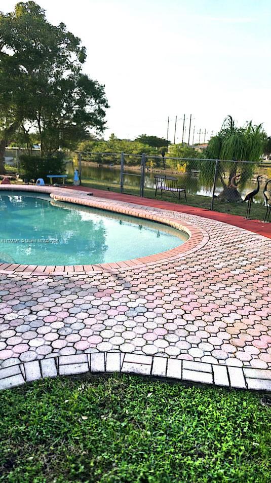view of swimming pool with a fenced in pool, a patio, and fence