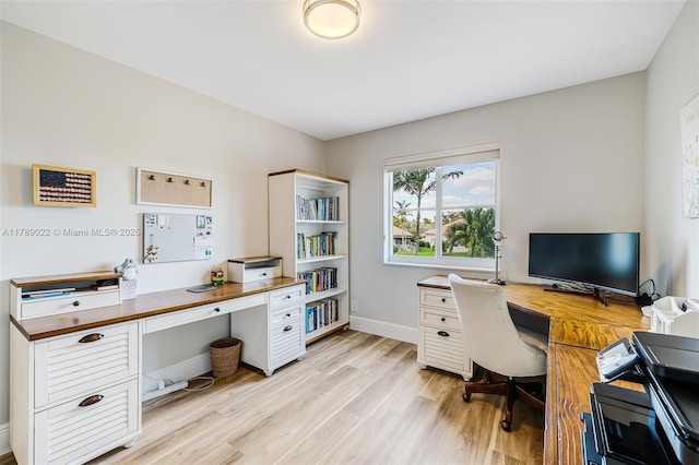 home office featuring light wood-type flooring and baseboards