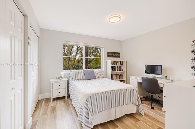bedroom with light wood-style floors and baseboards
