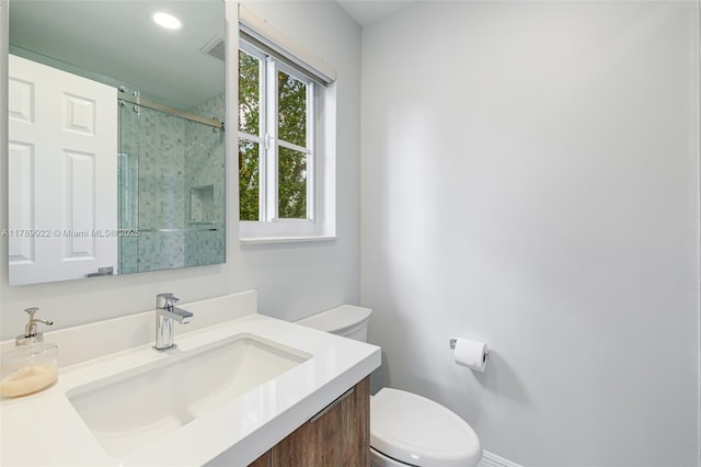 full bath featuring a shower stall, toilet, and vanity