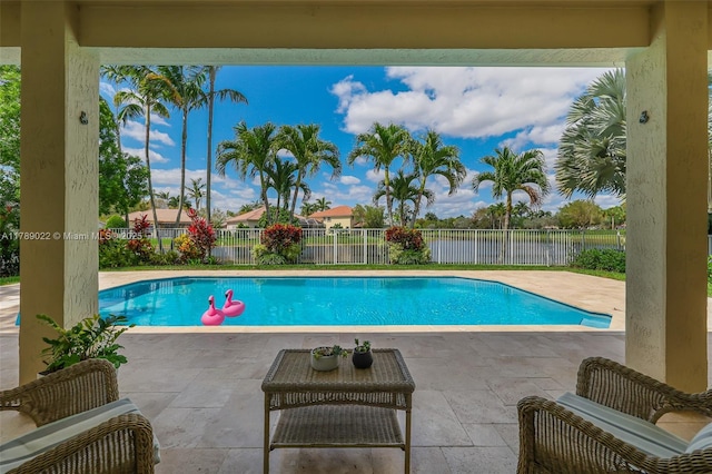 view of swimming pool with a fenced in pool, a fenced backyard, a patio, and a water view