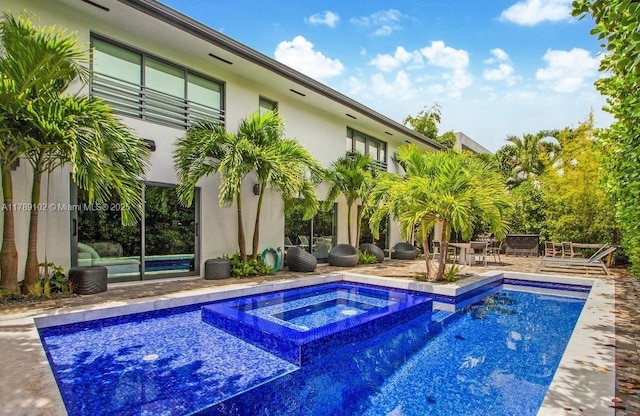 view of pool featuring a patio area and a pool with connected hot tub