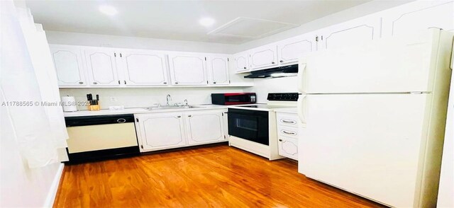 497 W Tilford W Unit W, Deerfield Beach, FL 33442 - kitchen featuring white cabinets, a sink, wood finished floors, white appliances, and under cabinet range hood