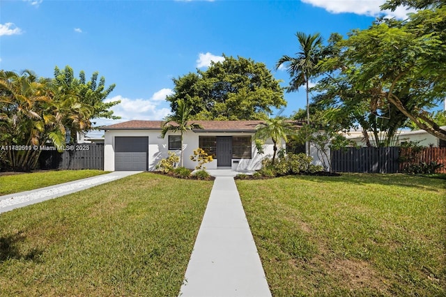 ranch-style home with concrete driveway, an attached garage, fence, and a front lawn