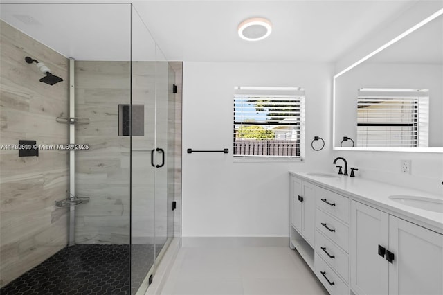 full bathroom with tile patterned flooring, a sink, double vanity, and a stall shower
