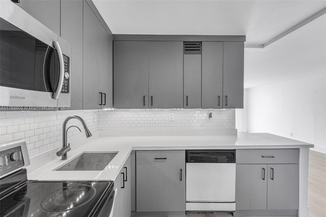 6900 Bay Dr Unit 11F, Miami Beach, FL 33141 - kitchen featuring gray cabinetry and appliances with stainless steel finishes