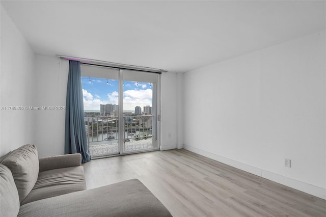 6900 Bay Dr Unit 11F, Miami Beach, FL 33141 - living room with baseboards, a city view, a water view, and wood finished floors