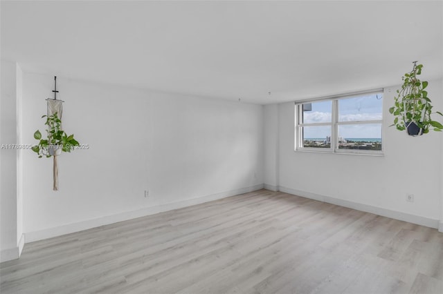 6900 Bay Dr Unit 11F, Miami Beach, FL 33141 - spare room with baseboards and wood finished floors
