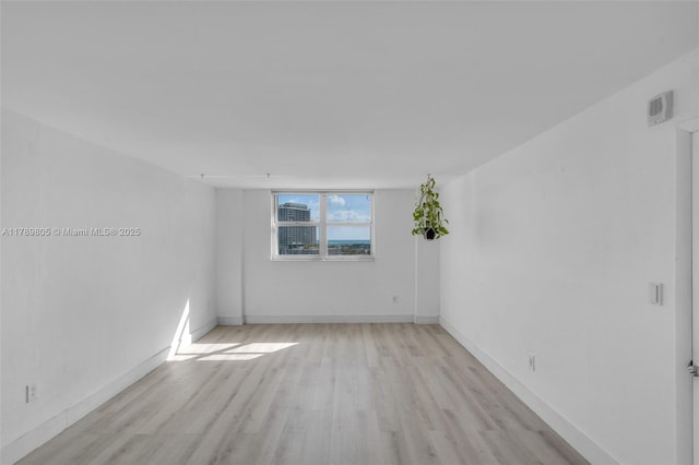 6900 Bay Dr Unit 11F, Miami Beach, FL 33141 - empty room with baseboards and light wood finished floors