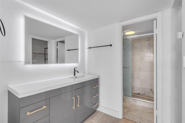 6900 Bay Dr Unit 11F, Miami Beach, FL 33141 - bathroom featuring vanity, baseboards, and a stall shower