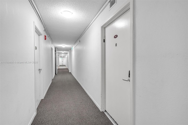 6900 Bay Dr Unit 11F, Miami Beach, FL 33141 - corridor featuring baseboards, carpet, a textured ceiling, and visible vents