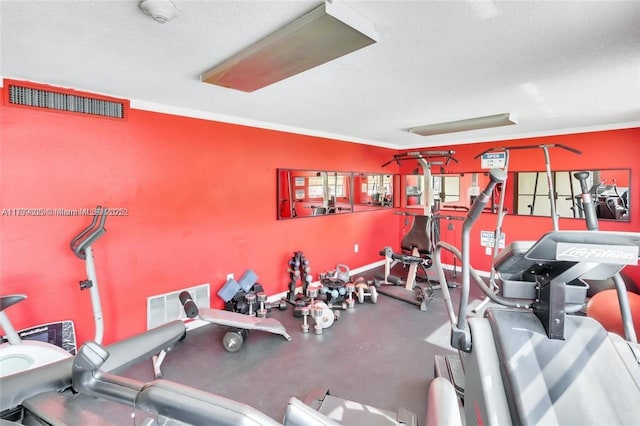 6900 Bay Dr Unit 11F, Miami Beach, FL 33141 - gym with visible vents, ornamental molding, and a textured ceiling