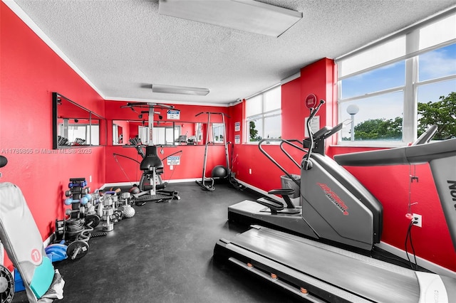 6900 Bay Dr Unit 11F, Miami Beach, FL 33141 - workout area featuring baseboards and a textured ceiling