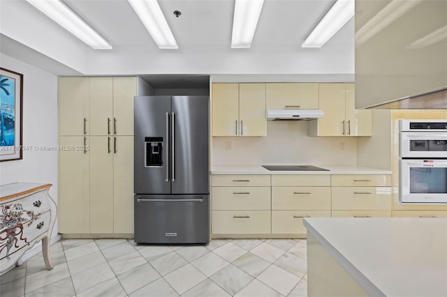 520 Brickell Key Dr Unit A201, Miami, FL 33131 - kitchen with stainless steel refrigerator with ice dispenser, white double oven, light countertops, and cream cabinets