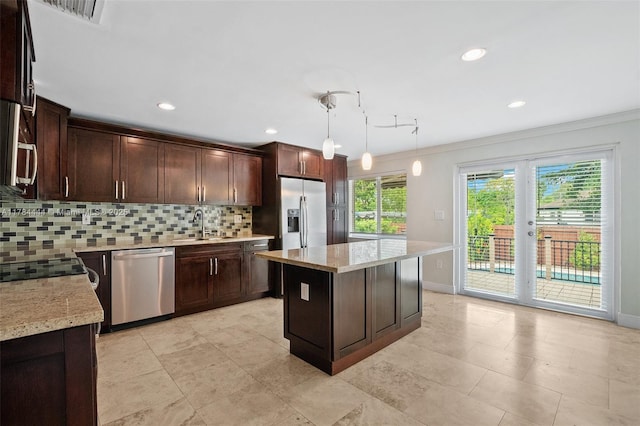 kitchen featuring stainless steel appliances, decorative backsplash, ornamental molding, and dark brown cabinetry