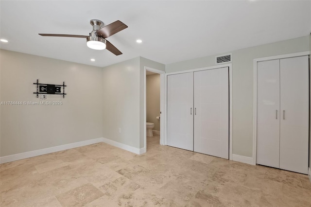 unfurnished bedroom featuring baseboards, visible vents, two closets, and recessed lighting
