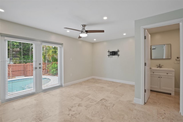 empty room with a sink, ceiling fan, baseboards, recessed lighting, and french doors