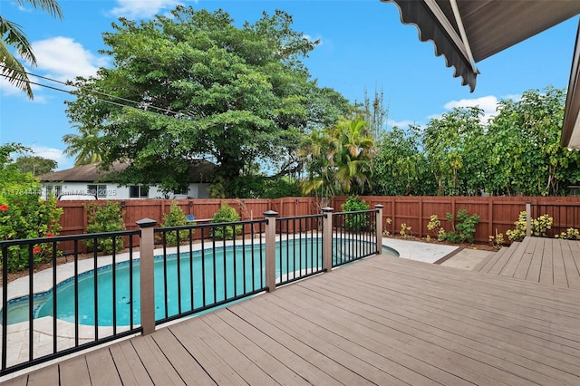 wooden deck featuring a fenced backyard and a fenced in pool