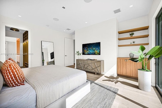 bedroom featuring visible vents and light wood-type flooring