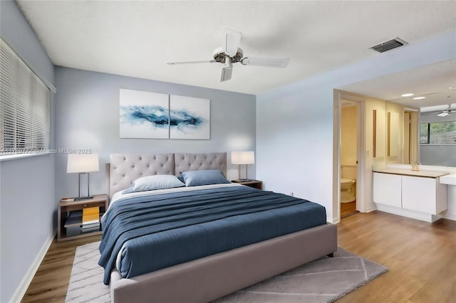 129 Chelsea Ln, Plantation, FL 33324 - bedroom with wood finished floors, visible vents, a ceiling fan, connected bathroom, and baseboards