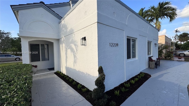 view of side of home with stucco siding