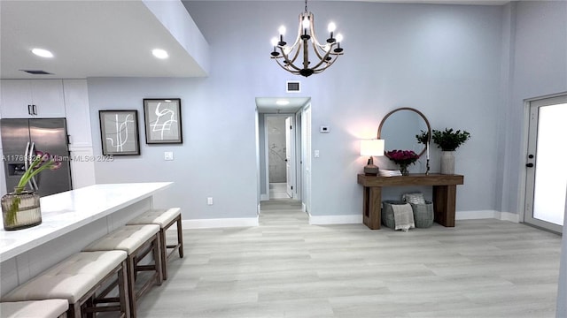 12239 NW 7th St, Miami, FL 33182 - foyer entrance featuring a chandelier, light wood-style floors, baseboards, recessed lighting, and a towering ceiling