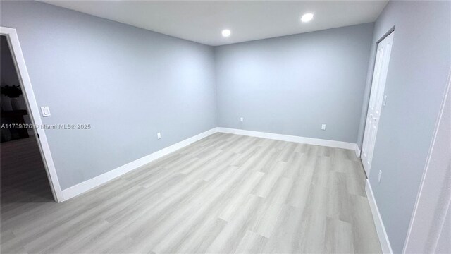 unfurnished room with recessed lighting, light wood-style floors, and baseboards