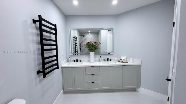 bathroom featuring walk in shower, baseboards, and a sink