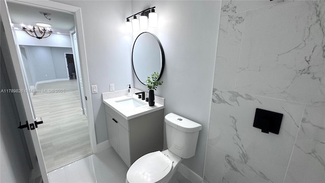 12239 NW 7th St, Miami, FL 33182 - bathroom featuring toilet, vanity, a chandelier, and baseboards