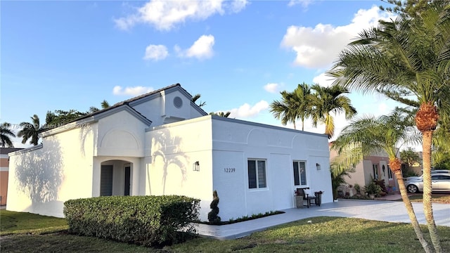 exterior space with a lawn and stucco siding
