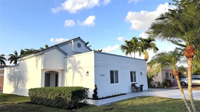 12239 NW 7th St, Miami, FL 33182 - view of side of property with stucco siding and concrete driveway