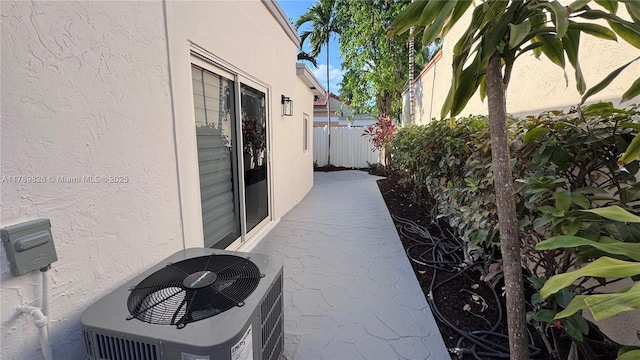 view of patio / terrace with fence and central air condition unit