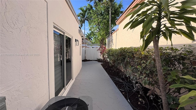 12239 NW 7th St, Miami, FL 33182 - view of side of home featuring stucco siding and cooling unit