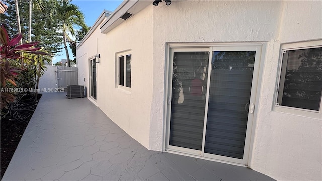 view of home's exterior featuring stucco siding and fence