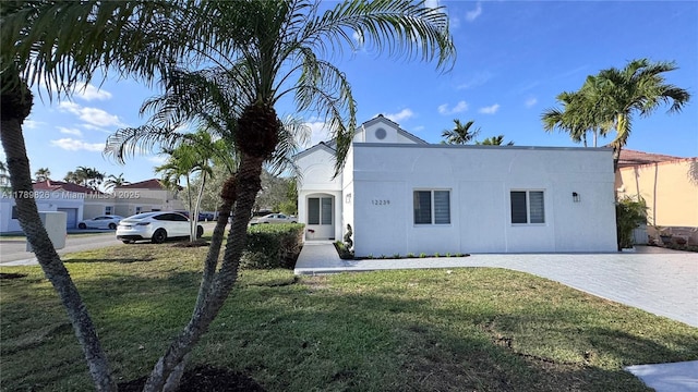 mediterranean / spanish house with stucco siding and a front yard
