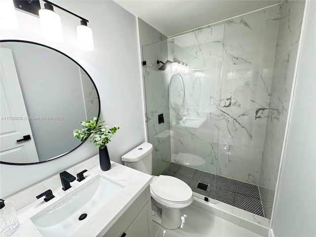 full bath featuring vanity, toilet, and a marble finish shower