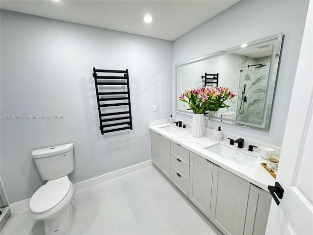 bathroom featuring a stall shower, toilet, double vanity, and a sink