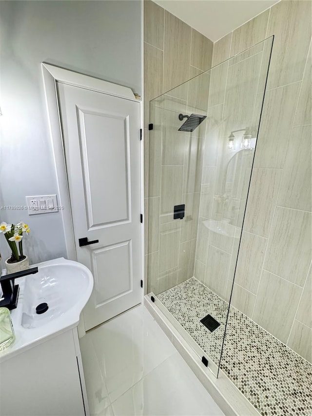 full bathroom featuring walk in shower, tile patterned flooring, and vanity
