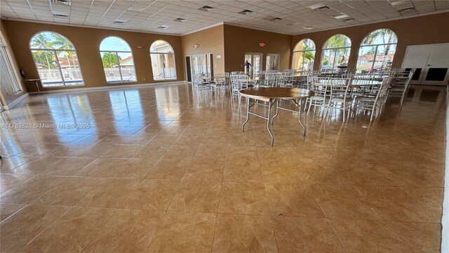 12239 NW 7th St, Miami, FL 33182 - dining space featuring a paneled ceiling, plenty of natural light, light tile patterned floors, and baseboards