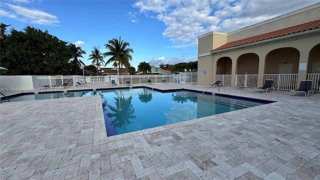 pool featuring a patio and fence