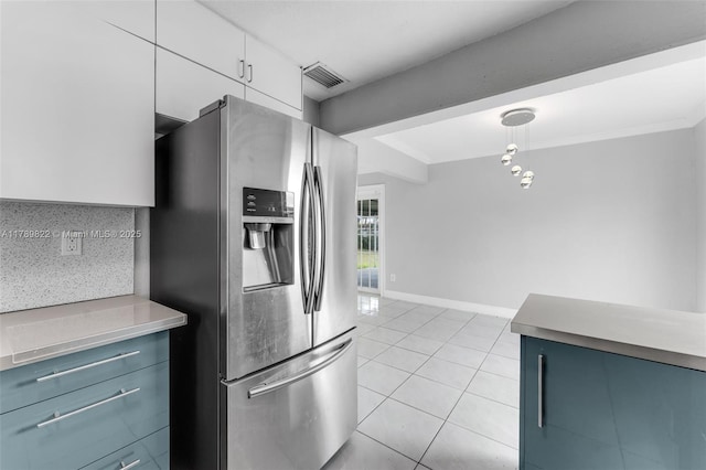 11024 SW 51st Ter, Miami, FL 33165 - kitchen featuring light countertops, visible vents, light tile patterned floors, stainless steel fridge, and white cabinetry