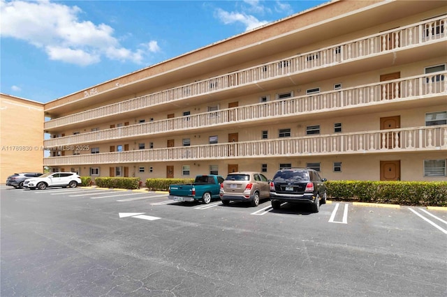 view of property featuring uncovered parking