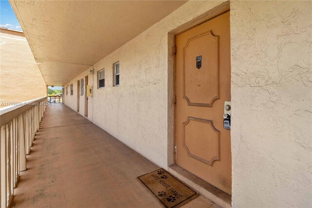 view of exterior entry with stucco siding