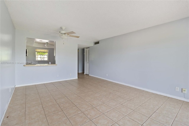 spare room with visible vents, light tile patterned floors, ceiling fan, and a textured ceiling