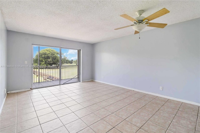 unfurnished room with light tile patterned floors, ceiling fan, and a textured ceiling