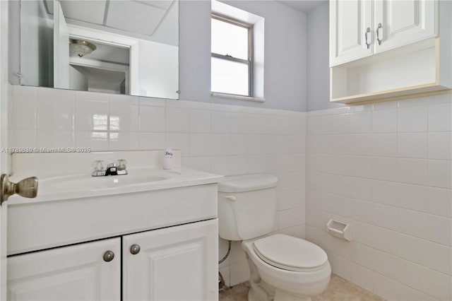 bathroom featuring tile walls, toilet, tile patterned flooring, and vanity