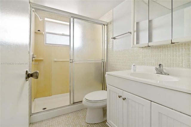 bathroom with decorative backsplash, a stall shower, toilet, tile patterned floors, and vanity
