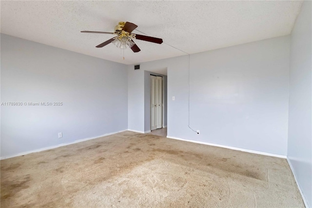 unfurnished room featuring visible vents, a ceiling fan, carpet flooring, and baseboards