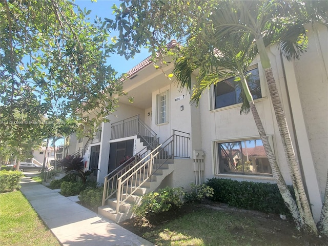 view of exterior entry featuring stucco siding