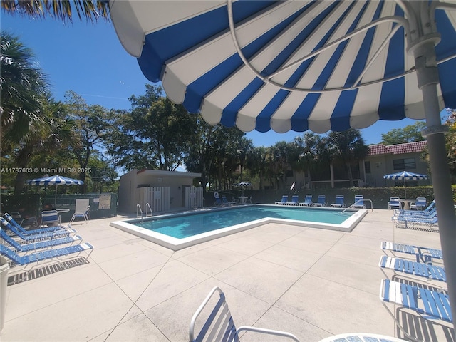 pool featuring a patio and fence